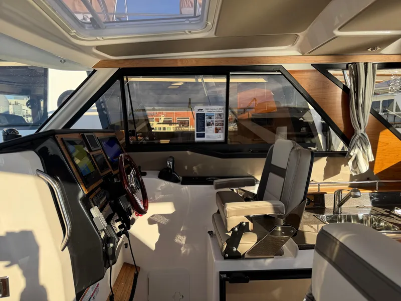 Slide: The Image of Interior of 2025 Cutwater C-288 Coupe boat, featuring modern helm and seating. - 17