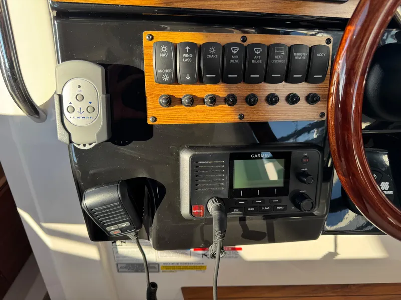 Slide: The Image of Control panel of 2025 Cutwater C-288 Coupe with switches and Garmin device. - 21