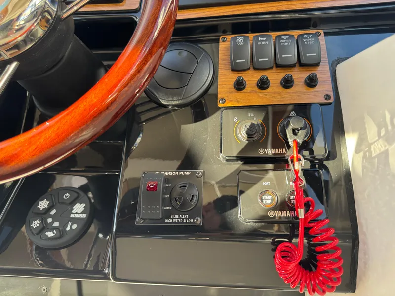 Slide: The Image of 2025 Cutwater C-288 Coupe dashboard with Yamaha controls and wooden steering wheel. - 22