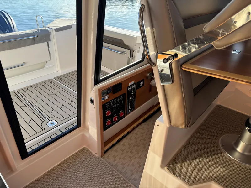 Slide: The Image of 2025 Cutwater C-288 Coupe interior with control panel and seating, overlooking deck and water. - 28