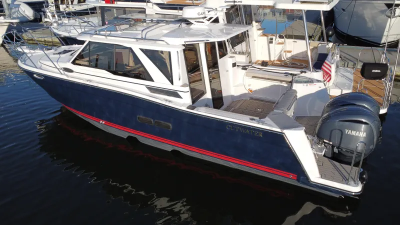 Slide: The Image of 2025 Cutwater C-288 Coupe boat docked, featuring sleek design and Yamaha outboard motor. - 3