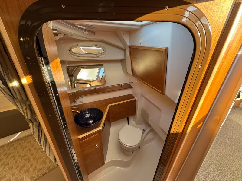 Slide: The Image of 2025 Cutwater C-288 Coupe bathroom with wooden cabinetry and modern fixtures. - 33