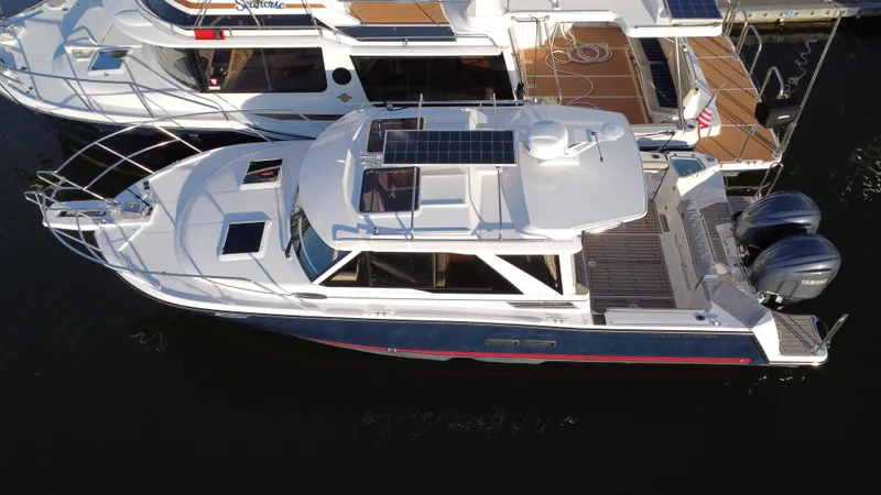 Slide: The Image of 2025 Cutwater C-288 Coupe boat docked, aerial view showcasing sleek design and dual engines. - 4