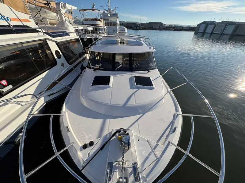 Slide: The Image of 2025 Cutwater C-288 Coupe docked in a marina, showcasing sleek design and modern features. - 45