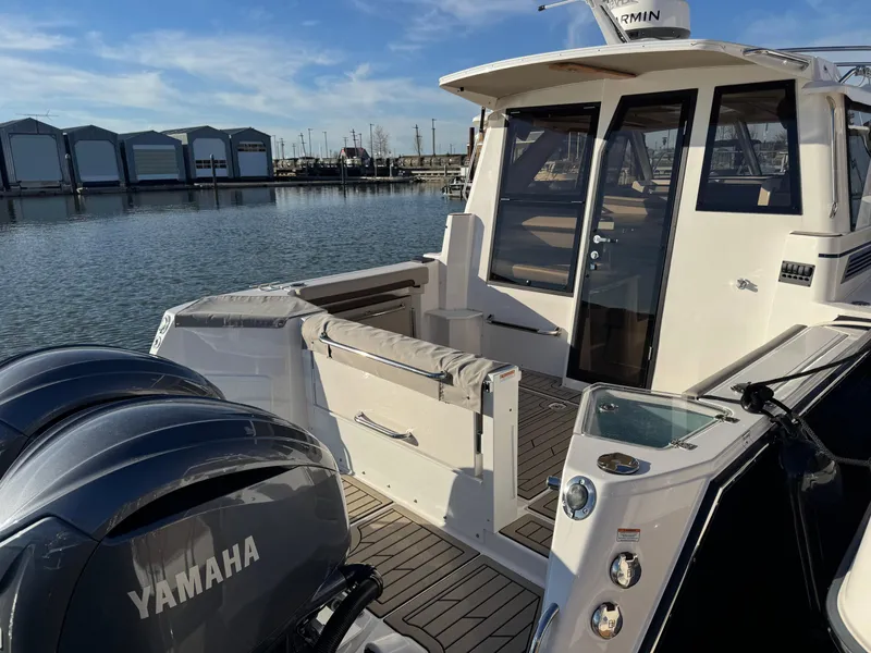 Slide: The Image of 2025 Cutwater C-288 Coupe boat with Yamaha engines docked by the marina. - 6