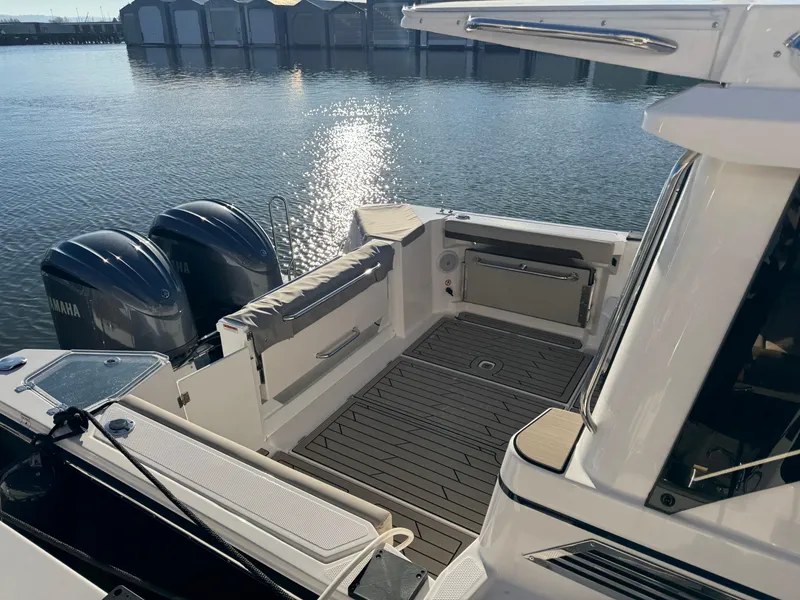 Slide: The Image of 2025 Cutwater C-288 Coupe boat with dual Yamaha engines, docked by calm waters. - 7