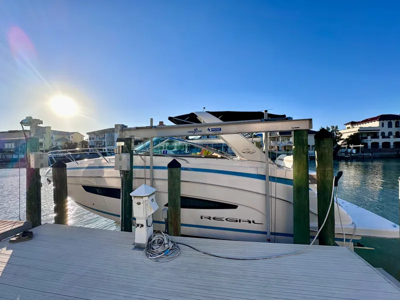 Slide: The Image of 2017 Regal 32 Express boat docked at marina during sunset. - 1