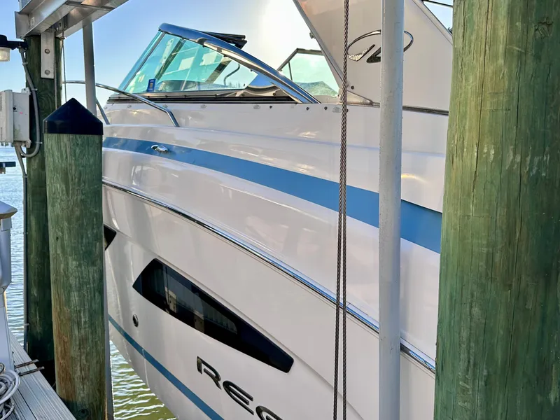 Slide: The Image of 2017 Regal 32 Express boat docked, featuring sleek design and blue accents. - 10
