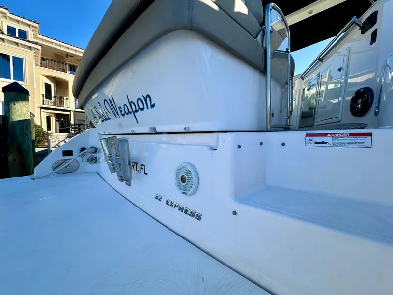 Slide: The Image of 2017 Regal 32 Express boat docked, showcasing sleek design and modern features. - 13