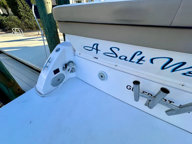 Slide: The Image of 2017 Regal 32 Express boat with "A Salt" name, docked, featuring rod holders and speaker. - 14