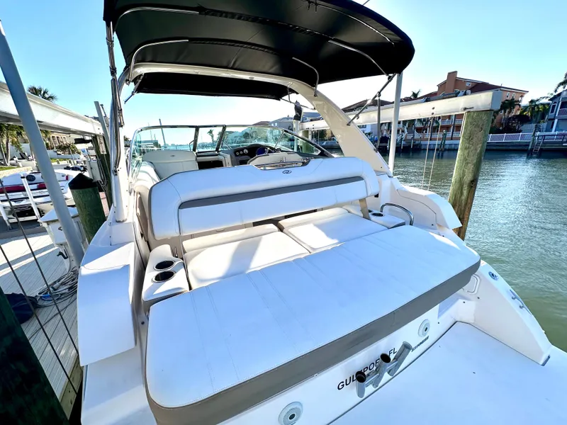 Slide: The Image of 2017 Regal 32 Express boat with spacious seating and canopy, docked by the water. - 15