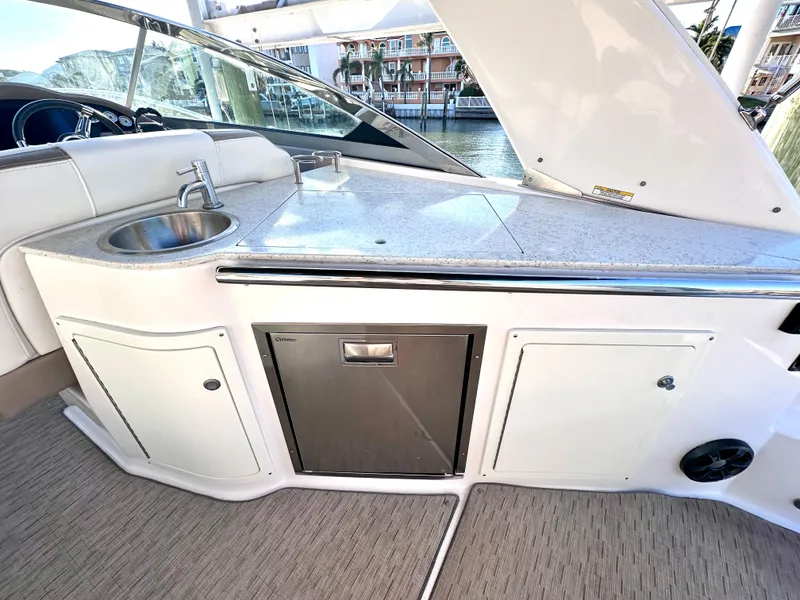 Slide: The Image of 2017 Regal 32 Express yacht kitchenette with sink and storage cabinets. - 20