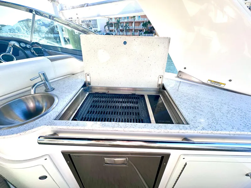Slide: The Image of Outdoor kitchen on a 2017 Regal 32 Express yacht with grill and sink. - 21