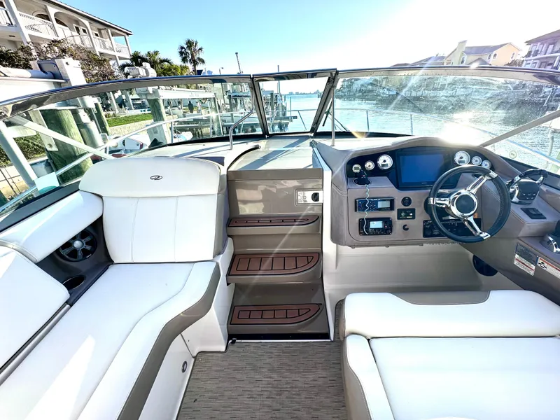 Slide: The Image of 2017 Regal 32 Express boat interior with modern dashboard and white seating. - 22
