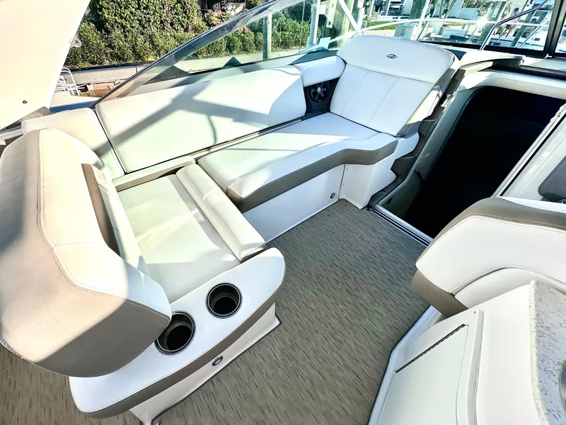 Slide: The Image of 2017 Regal 32 Express boat interior with beige seating and cup holders. - 23