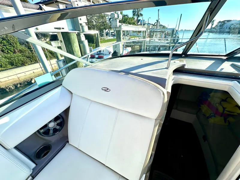 Slide: The Image of 2017 Regal 32 Express boat interior with white seating and waterfront view. - 26