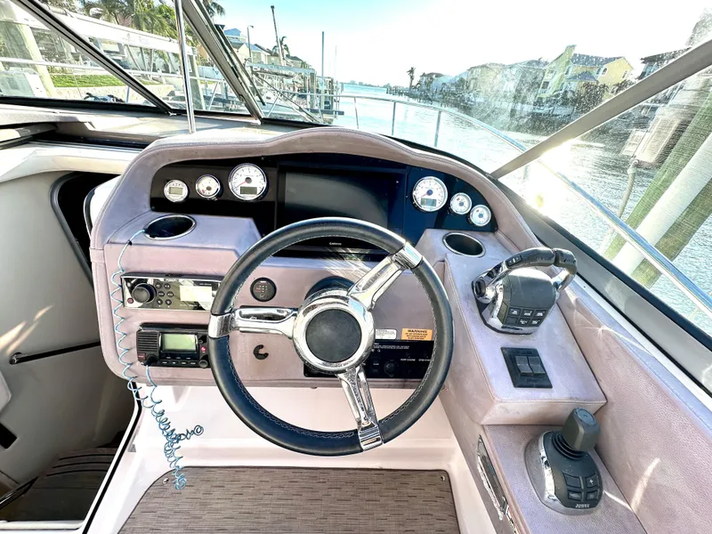 Slide: The Image of Cockpit of 2017 Regal 32 Express boat with steering wheel and control panel. - 28