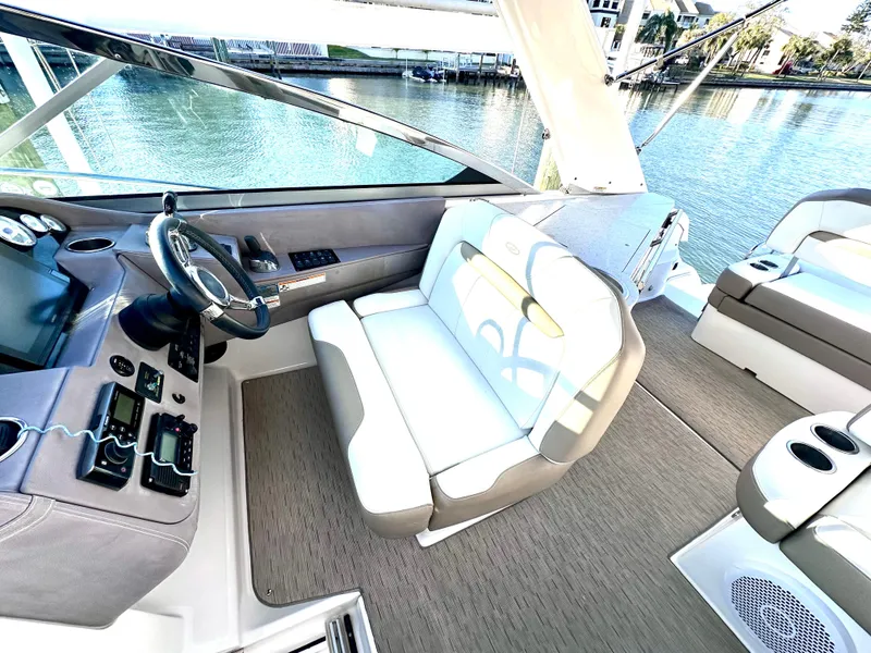 Slide: The Image of 2017 Regal 32 Express boat interior with helm, seating, and water view. - 30