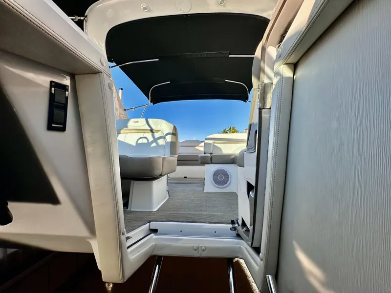 Slide: The Image of 2017 Regal 32 Express boat interior with seating and canopy, showcasing modern design. - 34