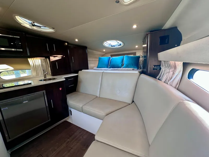 Slide: The Image of 2017 Regal 32 Express cabin interior with modern kitchen, seating, and skylights. - 35