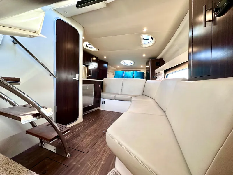 Slide: The Image of 2017 Regal 32 Express yacht interior with modern seating and elegant wood finishes. - 36