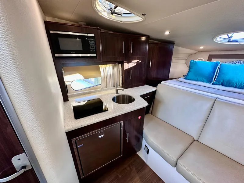 Slide: The Image of Interior of 2017 Regal 32 Express yacht with kitchenette and seating area. - 39