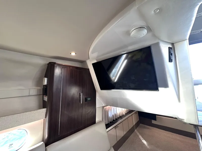 Slide: The Image of 2017 Regal 32 Express interior with TV, cabinet, and seating area. - 43
