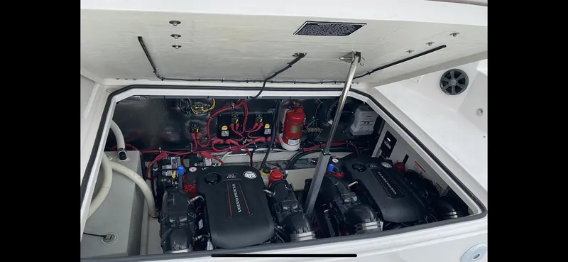 Slide: The Image of Engine compartment of a 2017 Regal 32 Express boat, showcasing dual engines and wiring. - 49