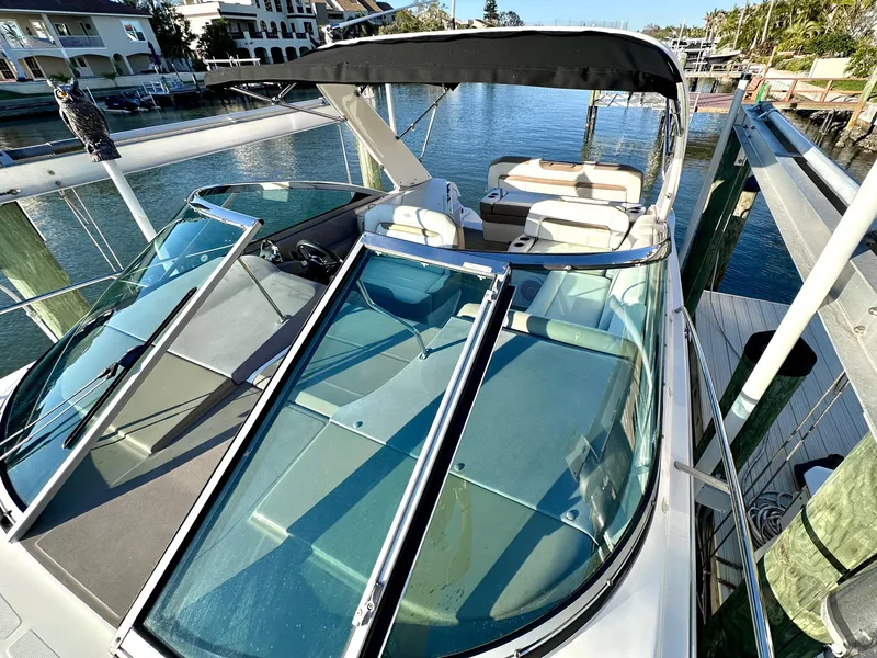 Slide: The Image of 2017 Regal 32 Express boat docked, featuring spacious seating and sleek design. - 5