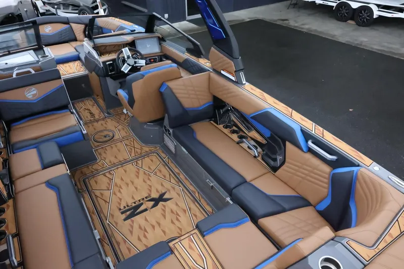 Slide: The Image of 2025 Tigé Ultré 25ZX boat interior with luxurious seating and modern dashboard. - 13