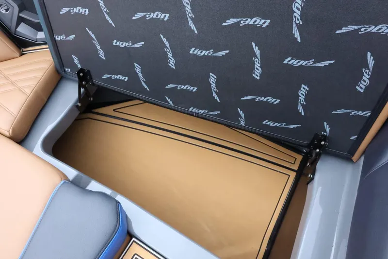 Slide: The Image of 2025 Tigé Ultré 25ZX boat storage compartment with branded interior lining. - 21