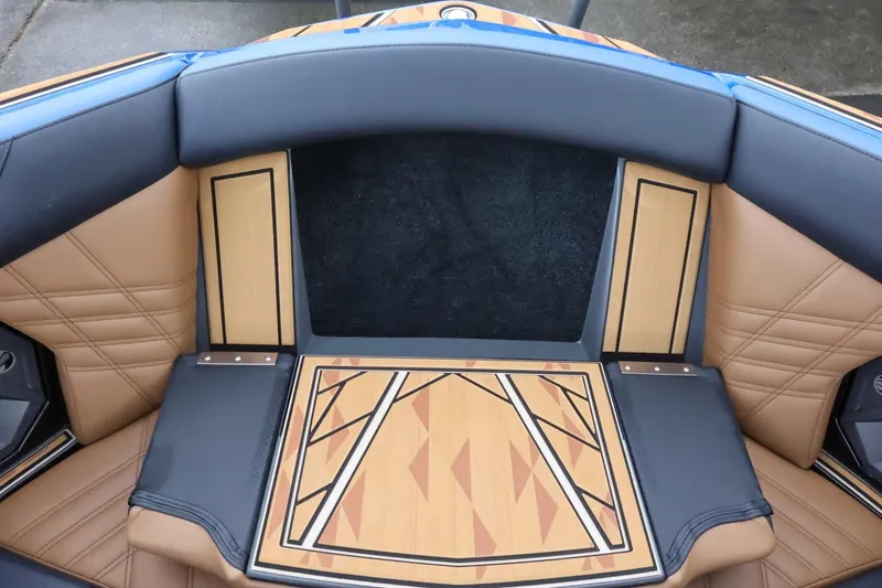 Slide: The Image of 2025 Tigé Ultré 25ZX boat interior with stylish tan and black seating. - 23