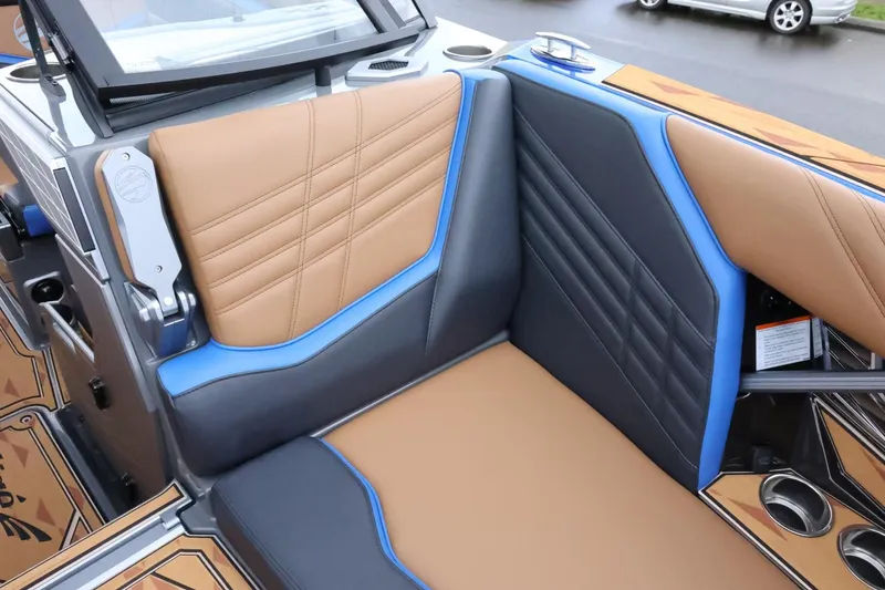 Slide: The Image of 2025 Tigé Ultré 25ZX boat interior with tan and blue seating. - 25