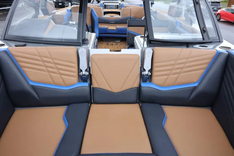Slide: The Image of 2025 Tigé Ultré 25ZX boat interior with tan and blue seating, showcasing modern design. - 26