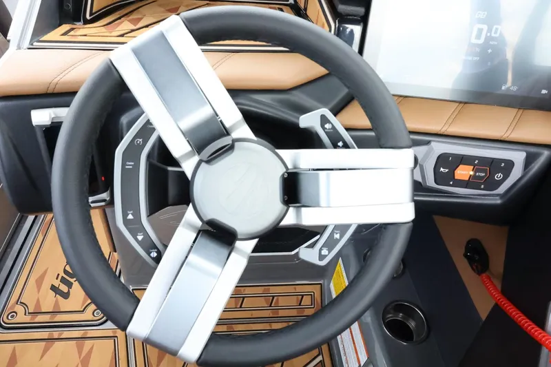 Slide: The Image of Steering wheel of 2025 Tigé Ultré 25ZX boat with modern dashboard controls. - 30