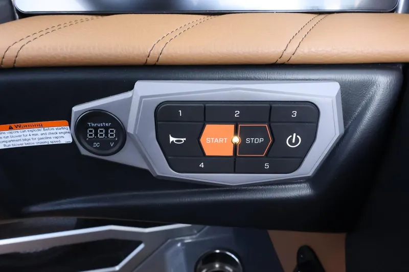 Slide: The Image of Control panel of 2025 Tigé Ultré 25ZX boat with start/stop button and digital display. - 37
