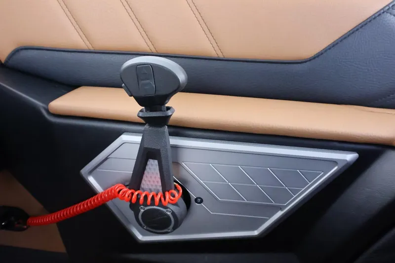 Slide: The Image of Interior detail of 2025 Tigé Ultré 25ZX boat with modern design and red coiled cable. - 38