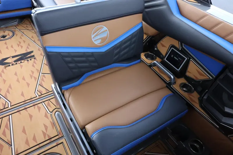 Slide: The Image of 2025 Tigé Ultré 25ZX boat interior with brown and blue seating, stylish design. - 40