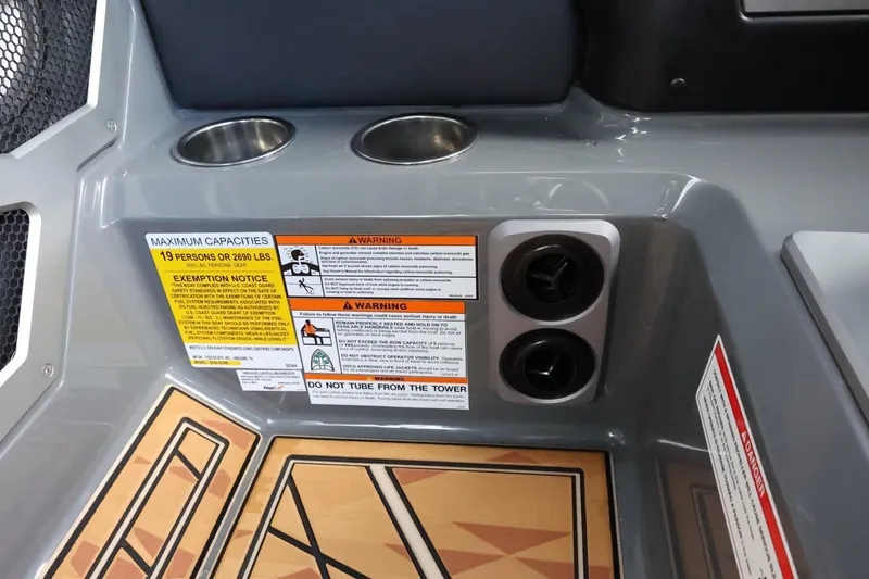 Slide: The Image of Interior of 2025 Tigé Ultré 25ZX boat with cup holders and safety warnings. - 46