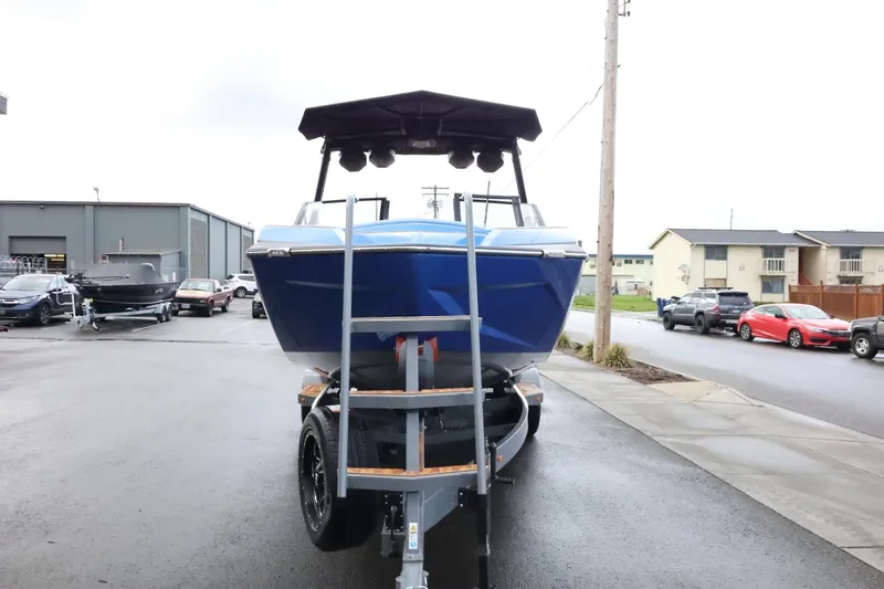 Slide: The Image of 2025 Tigé Ultré 25ZX boat on trailer, parked outdoors, front view. - 7