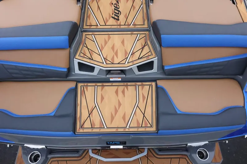 Slide: The Image of 2025 Tigé Ultré 25ZX boat interior with geometric wood and blue accents. - 9