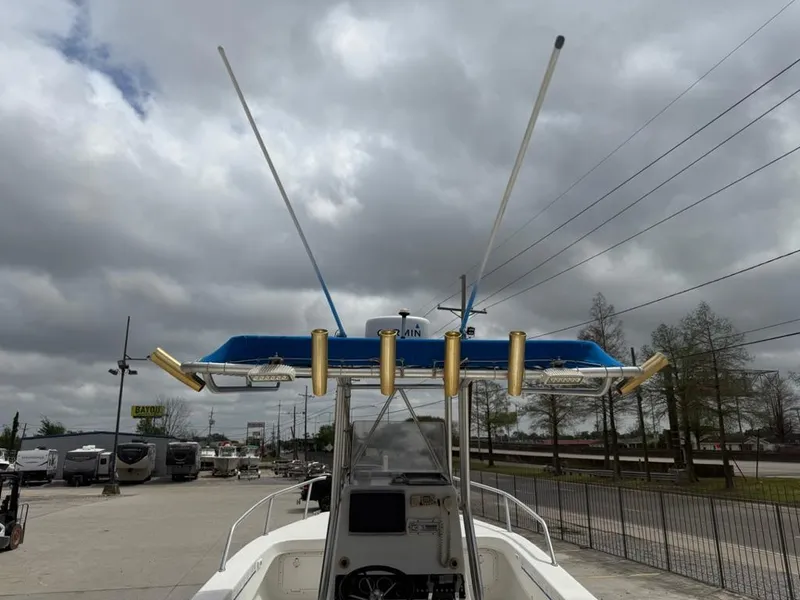 Slide: The Image of 2005 Twin Vee 26 Center Console boat with antennas and rod holders, under cloudy sky. - 13