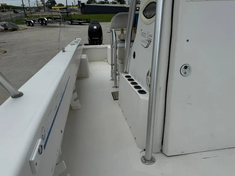 Slide: The Image of 2005 Twin Vee 26 Center Console boat interior with rod holders and console view. - 14