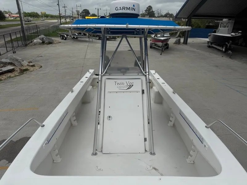 Slide: The Image of 2005 Twin Vee 26 Center Console boat with Garmin equipment, docked outdoors. - 7