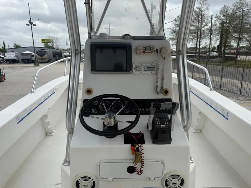 Slide: The Image of 2005 Twin Vee 26 Center Console boat dashboard with steering wheel and navigation equipment. - 9