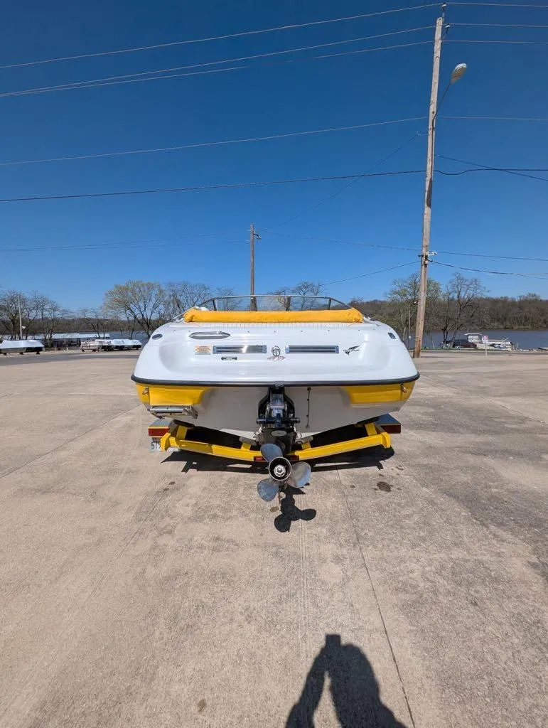 Slide: The Image of 2006 Crownline 180 BR boat on trailer, rear view, clear sky background. - 3