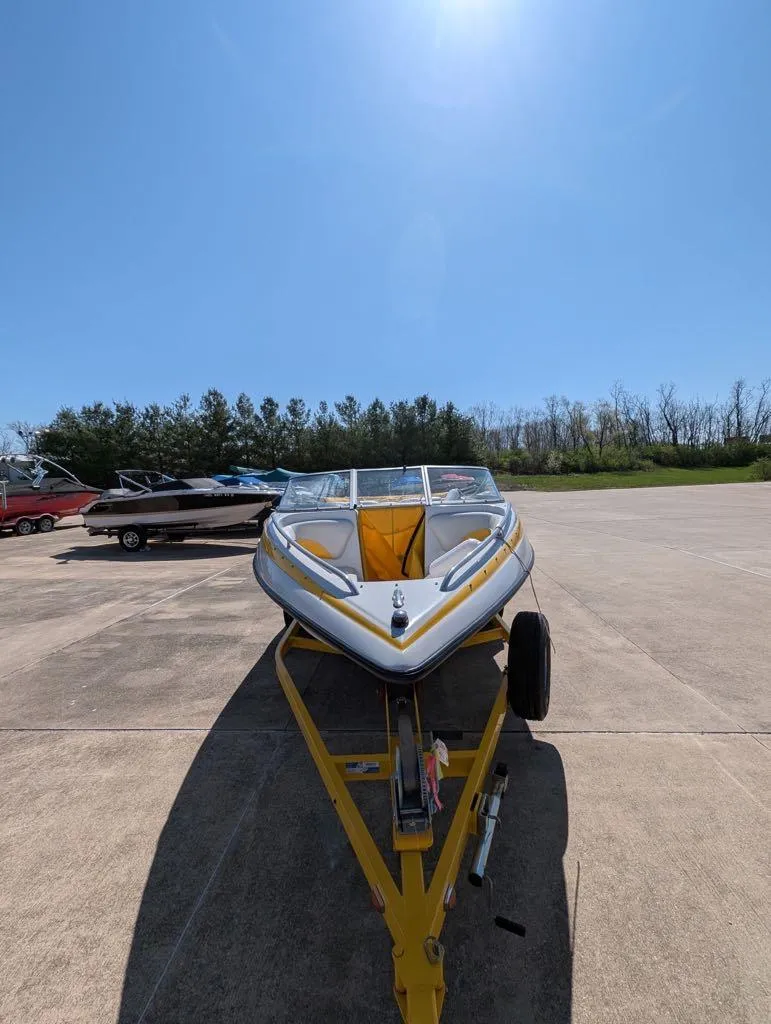 Slide: The Image of 2006 Crownline 180 BR boat on trailer under clear blue sky. - 7