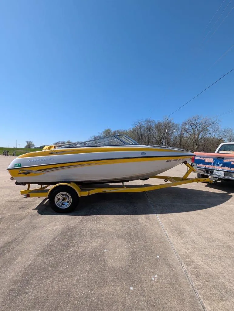 Slide: The Image of 2006 Crownline 180 BR boat on trailer, parked outdoors under clear blue sky. - 9