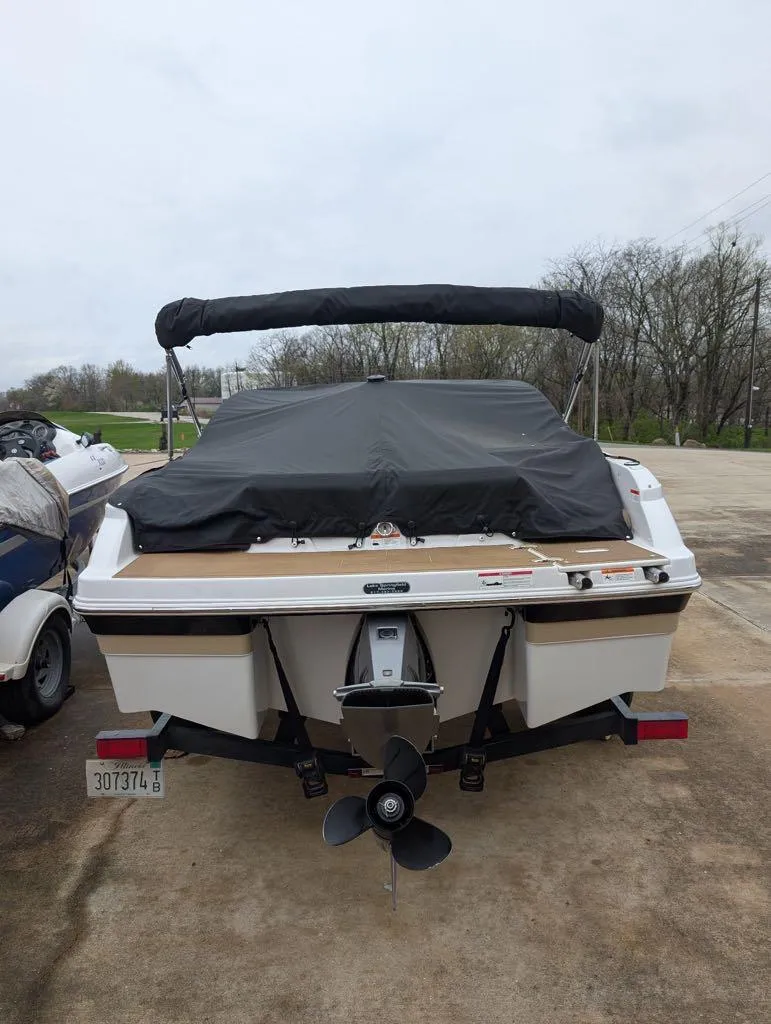 Slide: The Image of 2016 Four Winns 180 Horizon boat with cover, parked on a trailer. - 10