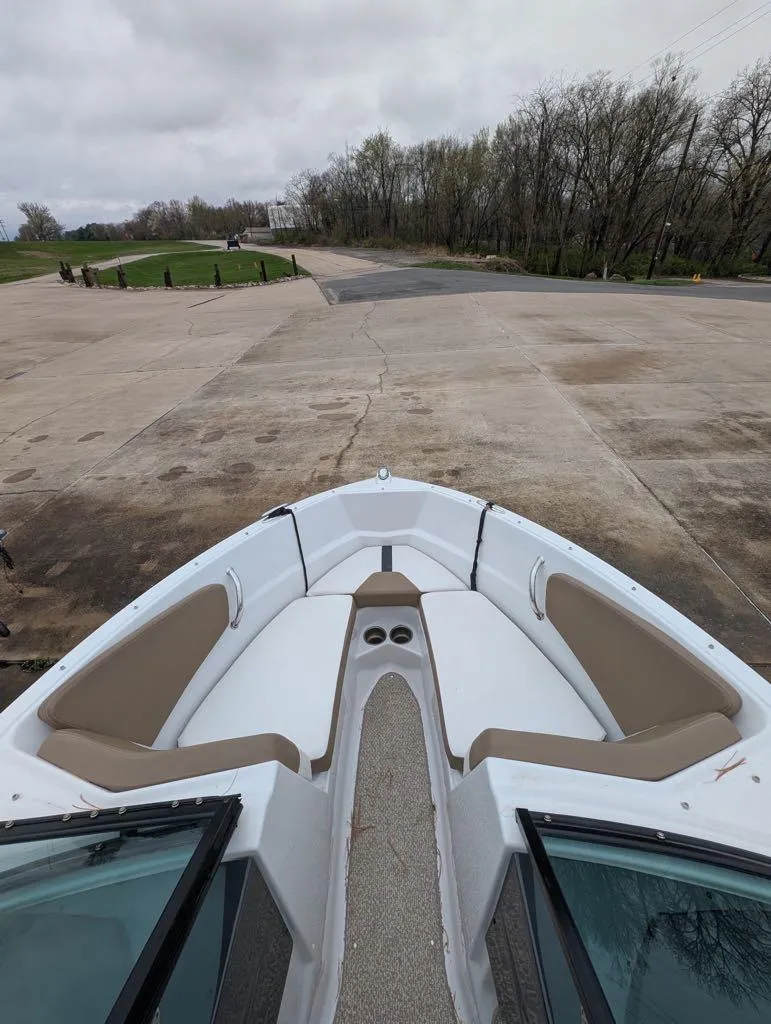 Slide: The Image of 2016 Four Winns 180 Horizon boat interior at a dock, featuring beige seating. - 11